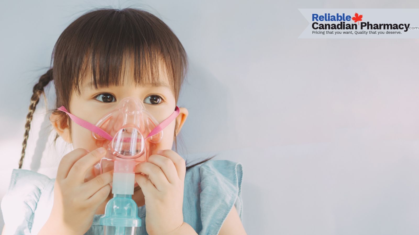 A little girl with nebulizer mask on.