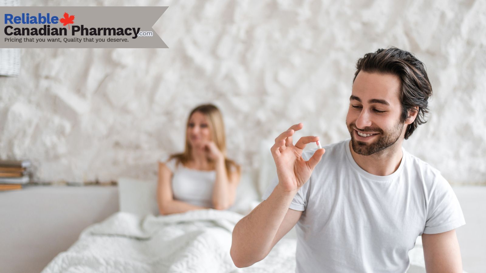 A couple on bed with the man holding a pill in his hand.